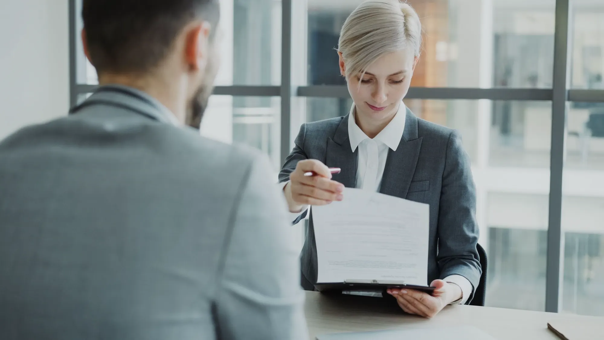 A business team reviewing a contract at a meeting table