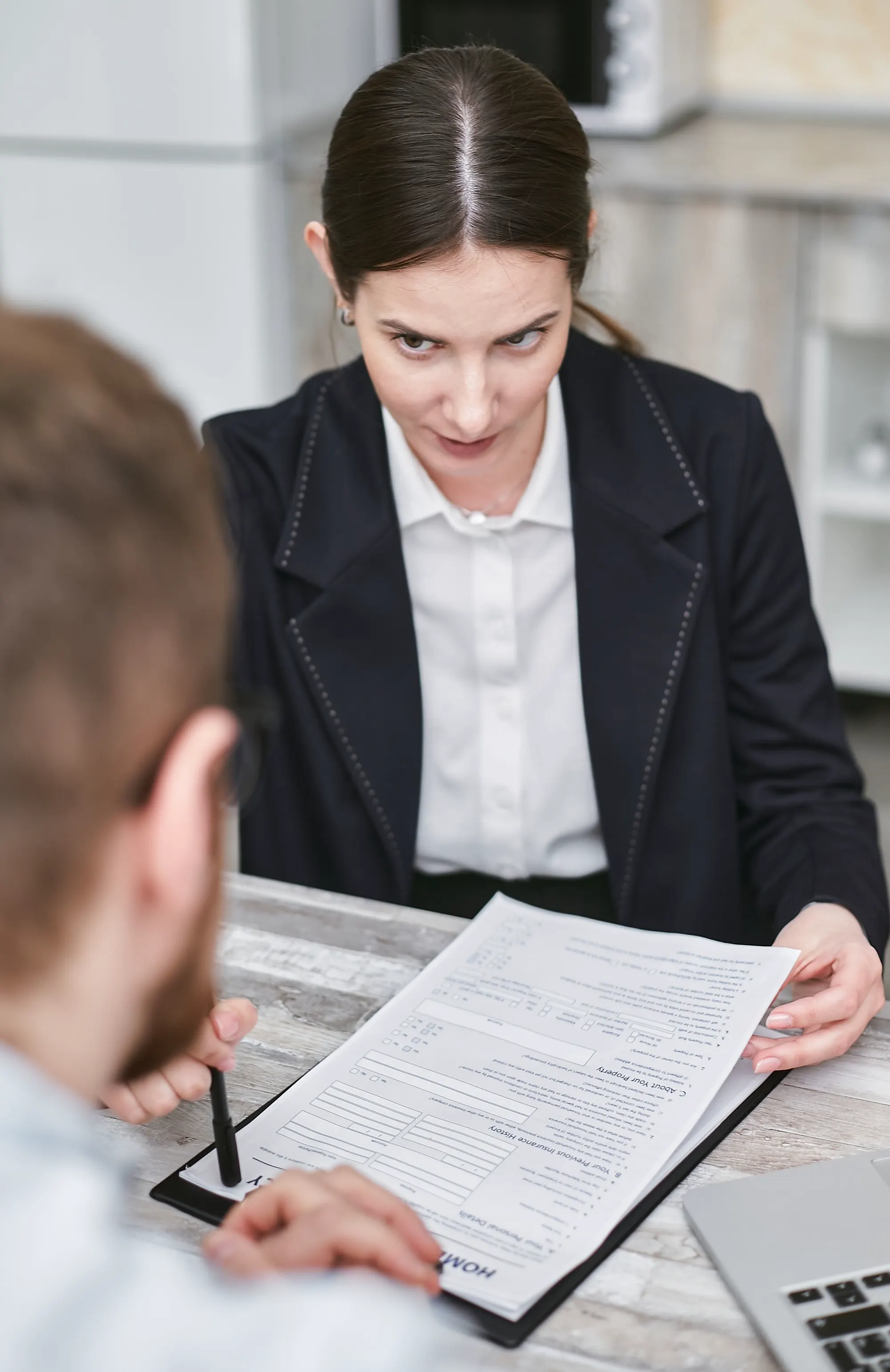 A professional reviewing documents with a business contact