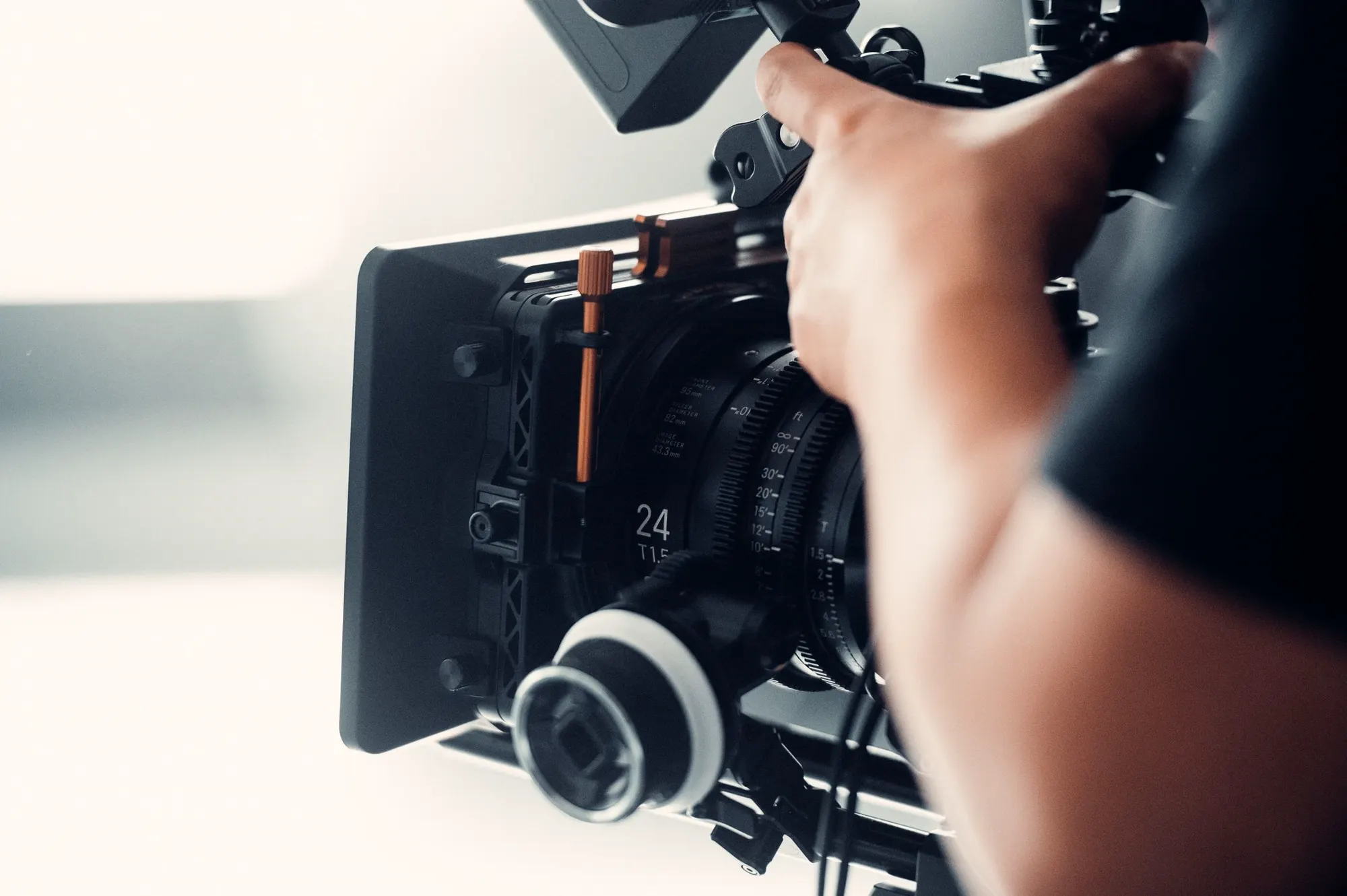 A camera operator preparing production equipment